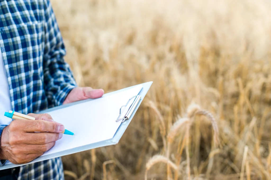 Un homme prenant des notes sur un presse papier